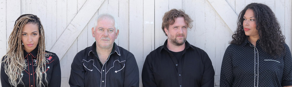 Jon Langford has grit in his voice and melody in his soul. A punk-rock pioneer, a leading light of alt-country, a troubadour for our times, a musicians' mentor, a visual artist of uncommon skill, a singer-songwriter who writes with the authority of having lived a life rather just having imagined it, how do you peg Langford? Is he folk, rock, country, punk, what? Yes, he's all that. Langford is Langford, a transplanted Welshman who's been in Chicago long enough for us to claim him, and in doing so, stake a claim to a treasure.   — New City Chicago   Summarizing Jon Langford’s contributions to punk rock and all of its permutations, as well as his career-long obsession with American roots music, is liable to overwhelm anyone.   — LA Times   Jon Langford boasts a unique creative energy, unless you can name another individual who helped pioneer cowpunk (The Mekons'  Fear And Whiskey ) while contributing artwork to craft breweries (Dogfish Head).   — SPIN   Jon Langford has established a lofty standard of brawny melodicism and personally and politically charged songcraft, building a formidable songbook on a foundation of stubborn humanism and a finely honed sense of the absurd.   — Austin Chronicle   Americana has not lost its grip on Langford, nor vice versa.   — Pitchfork   Let’s skip the history and instead focus on the primary constant – Langford’s barkeep approachability and an affable approach to political frustration and career disillusionment.   — LA Times    The great rock and roll bridge between punk's back alleys and country music's windswept plains.    — Portland Mercury